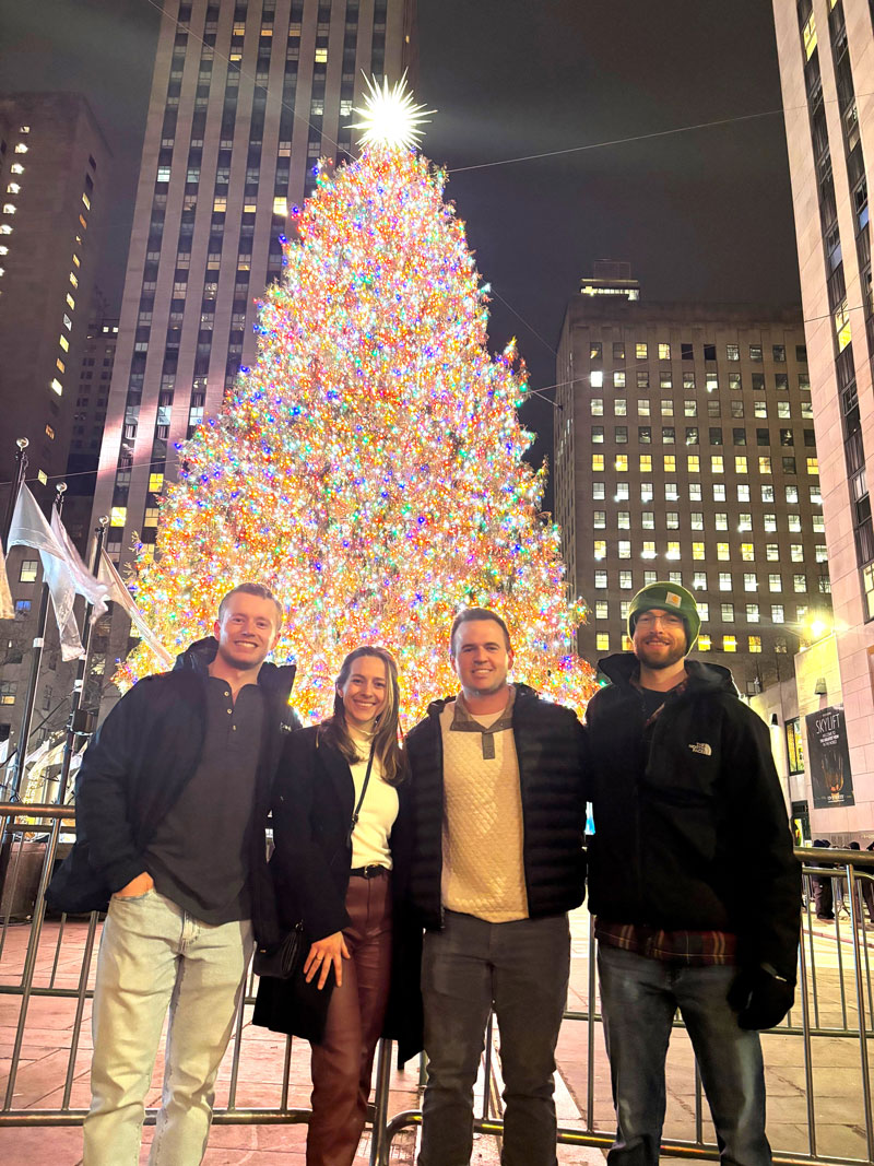 Four BCSC students stand in front of the Christmas tree at Rockefeller Center in New York City.